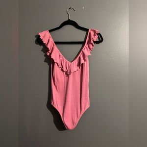 Wilfred pink bodysuit with frilly straps and neckline.